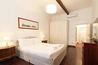 a bedroom with a large white bed and a window at Trastevere Essence by Nosdom Properties in Rome