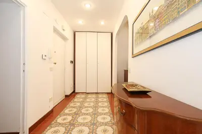 a hallway with a desk and a hallway with white doors at Trastevere Essence by Nosdom Properties in Rome