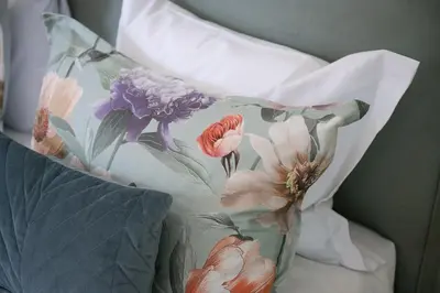 a pillow with a flower pattern on it at Trastevere Rooftop Terrace Courtyard Loft in Rome