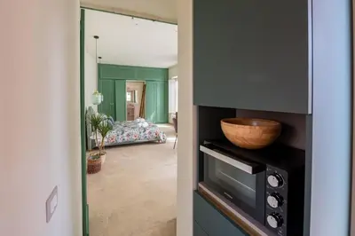 a kitchen with a bowl on top of a microwave at Trastevere Rooftop Terrace Courtyard Loft in Rome