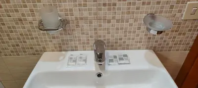 a sink with a faucet in a bathroom at House Fenicia in Rome