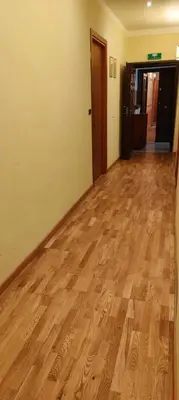 an empty room with a wooden floor and a hallway at House Fenicia in Rome