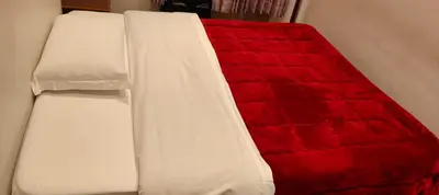 a red and white bed in a room at House Fenicia in Rome