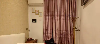 a room with a bed and a pink curtain at House Fenicia in Rome