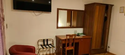 a room with a desk and a television on the wall at House Fenicia in Rome