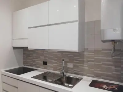 a kitchen with white cabinets and a sink at New Jebs sweet home Rome in Rome