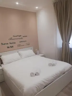 a bedroom with a white bed with two bows on it at New Jebs sweet home Rome in Rome