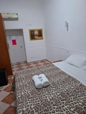 a bedroom with a bed with two towels on it at AFFITTACAMERe ROME PALACE in Rome