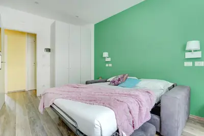 a bedroom with a large bed with a pink blanket at Marconi APT per Famiglie - 20 Min dal centro in Rome