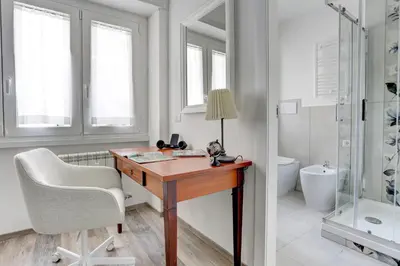 a bathroom with a desk and a chair and a shower at Marconi APT per Famiglie - 20 Min dal centro in Rome
