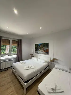 a bedroom with two beds with towels on them at Suite Rooms Garbatella in Rome