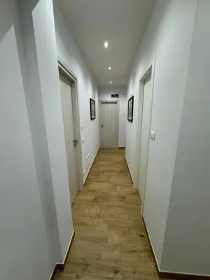 an empty hallway with white walls and wooden floors at Suite Rooms Garbatella in Rome