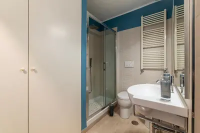 a bathroom with a sink and a shower and a toilet at Santa Maria alle Fornaci - FromHometoRome in Rome