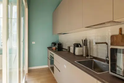 a kitchen with a sink and a counter at Santa Maria alle Fornaci - FromHometoRome in Rome