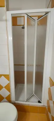 a shower stall in a bathroom with a toilet at Soggiorno Fenicia in Rome