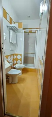 a bathroom with two toilets and a shower at Soggiorno Fenicia in Rome