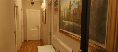 a hallway with paintings on the walls of a room at Soggiorno Fenicia in Rome