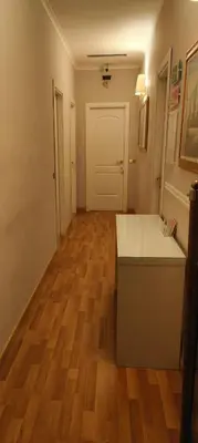 a room with a white counter and a wooden floor at Soggiorno Fenicia in Rome