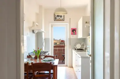a kitchen and dining room with a table and chairs at Casa Adele Lovely Mid-century Apartment, Rome in Rome