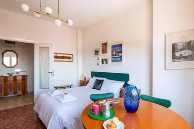 a bedroom with a bed and a wooden table at Casa Adele Lovely Mid-century Apartment, Rome in Rome