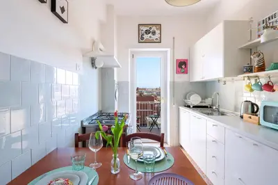 a kitchen with a table and a dining room at Casa Adele Lovely Mid-century Apartment, Rome in Rome