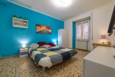 a blue bedroom with a bed with a blue wall at Lemon House in Rome