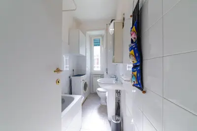 a white bathroom with a sink and a toilet at Lemon House in Rome