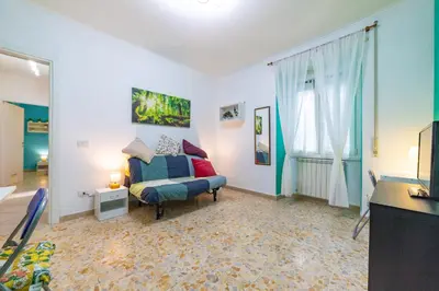 a living room with a couch and a window at Lemon House in Rome