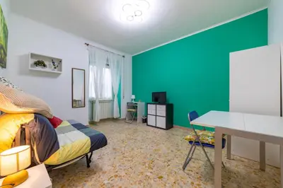 a room with a bed and a desk and a table at Lemon House in Rome