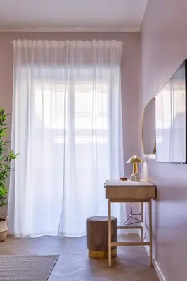 a white room with a table and a window at Amelie - Gem of Trastevere in Rome