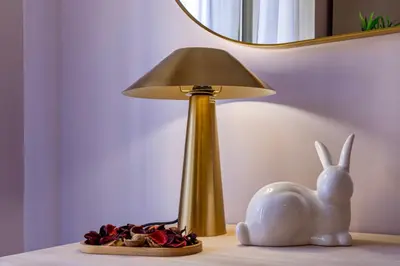 a lamp sitting on a table next to a toy rabbit at Amelie - Gem of Trastevere in Rome