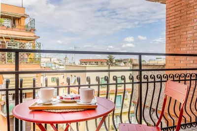 a table with two coffee cups on a balcony at Domvs Romana in Rome