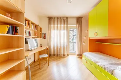 a bedroom with yellow and green cabinets and a bed at Furio Family Flat, A Few Steps from Metro A Stop in Rome
