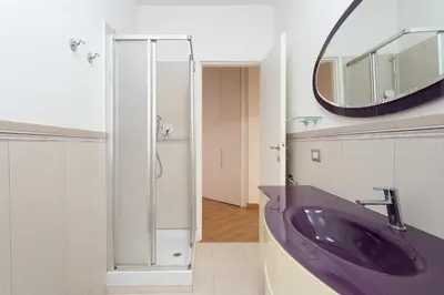 a bathroom with a purple sink and a mirror at Furio Family Flat, A Few Steps from Metro A Stop in Rome