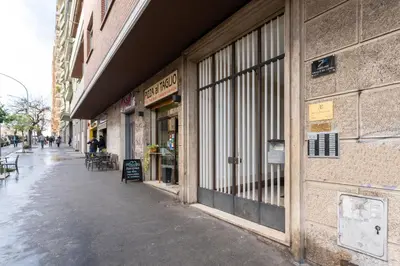 an empty sidewalk in front of a store at Furio Family Flat, A Few Steps from Metro A Stop in Rome
