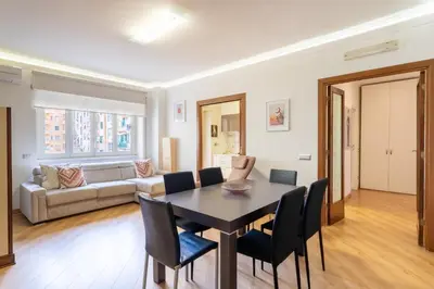a living room with a table and chairs and a couch at Furio Family Flat, A Few Steps from Metro A Stop in Rome