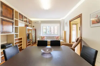 a living room with a table and chairs and a couch at Furio Family Flat, A Few Steps from Metro A Stop in Rome