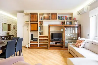 a living room with a couch and a television at Furio Family Flat, A Few Steps from Metro A Stop in Rome