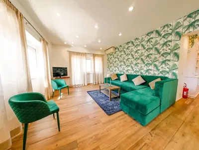 a living room with a green couch and chairs at Vatican Views Elegant Spacious e Unforgettable in Rome