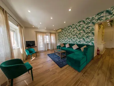 a living room with a green couch and chairs at Vatican Views Elegant Spacious e Unforgettable in Rome