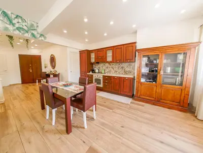 a kitchen with a table and chairs in a room at Vatican Views Elegant Spacious e Unforgettable in Rome