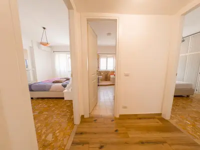 a hallway with a bedroom and a bed in a room at Vatican Views Elegant Spacious e Unforgettable in Rome