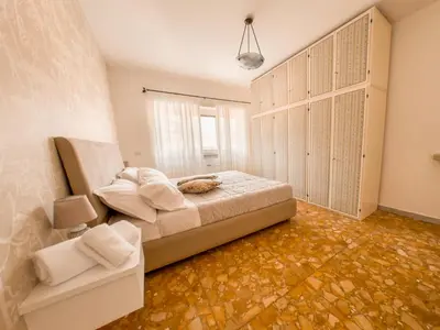 a bedroom with a bed in a room with orange floors at Vatican Views Elegant Spacious e Unforgettable in Rome