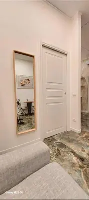 a living room with a mirror and a couch at Rome Center Bello Loft in Rome