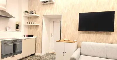 a living room with a couch and a television on a wall at Rome Center Bello Loft in Rome