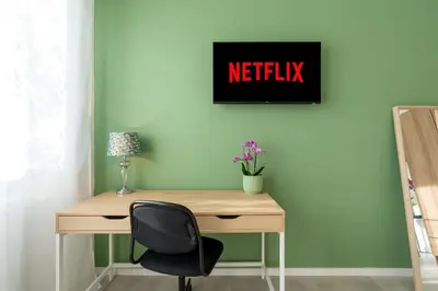 a desk with a chair and a sign that reads netflix at Domvs Tibvrtina - Solarium Zone, Terrace, A-C, Roma in Rome