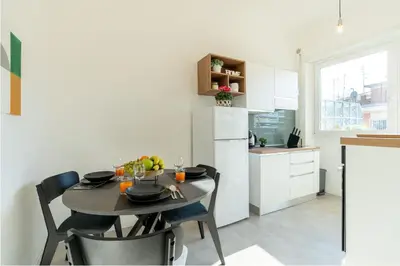 a kitchen with a table and chairs in a room at Domvs Tibvrtina - Solarium Zone, Terrace, A-C, Roma in Rome