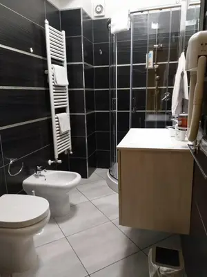 a bathroom with a toilet and a sink and a shower at Casa Carlo in Rome