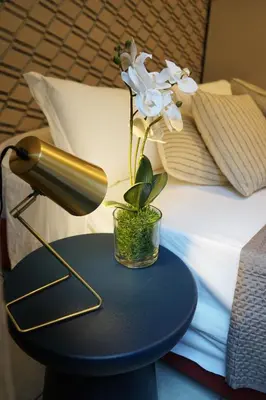 a lamp on a table next to a bed at Stay Smart Termini Esquilino in Rome