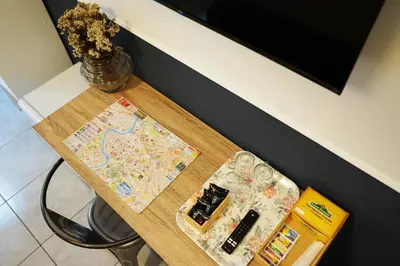 a table with a map and glasses on it at Stay Smart Termini Esquilino in Rome